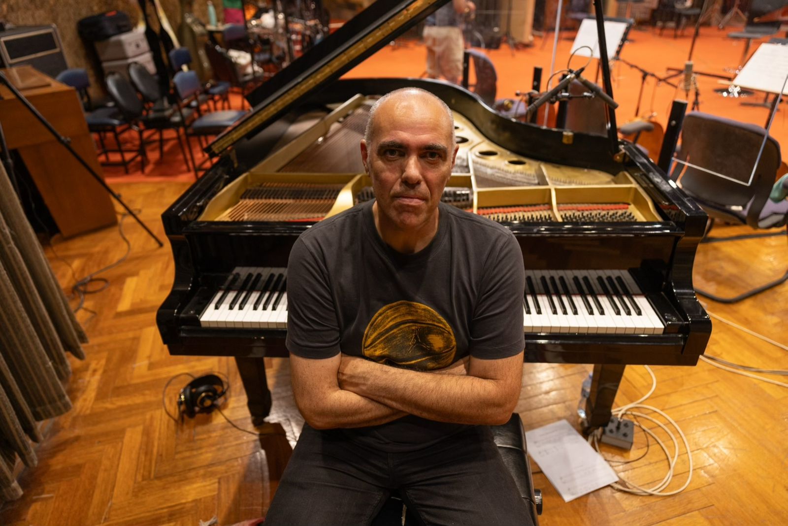 Antonis Skokos leaning on the piano